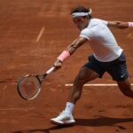 Rafael Nadal unleashes a powerful topspin forehand during his emotional first-round match at the French Open 2025 on the clay courts of Roland Garros.