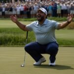 Golfer J.J. Spaun kneels in triumph on the 18th green at Flushing Meadows, New York, after clinching the 2025 US Open with a dramatic birdie putt, June 2025.