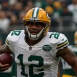 Micah Parsons, wearing a Green Bay Packers jersey, rushes the quarterback during a 2025 NFL game, showcasing his dynamic pass-rushing skills.