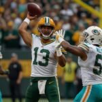 Green Bay Packers quarterback Jordan Love raises his arms in celebration after throwing a touchdown pass to Jayden Reed against the Miami Dolphins at Lambeau Field on September 21, 2025.