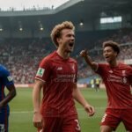 Liverpool players celebrate Florian Wirtz's equalizing goal against Yokohama F. Marinos during their 3-1 pre-season win at Nissan Stadium on July 30, 2025, with a vibrant crowd in the background.