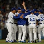 Los Angeles Dodgers players, including Mookie Betts and Shohei Ohtani, celebrate on the field at Dodger Stadium after a 4-3 victory against the Toronto Blue Jays in Game 3 of the 2025 World Series.