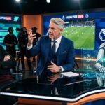 TV studio discussion with humanoid robot and sports analyst