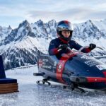 British Paralympic athlete with gold medal and bobsled in mountains